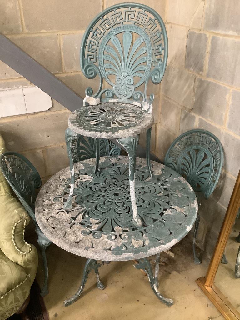 A Victorian style painted aluminium circular garden table with four chairs, table 81cm diameter height 67cm